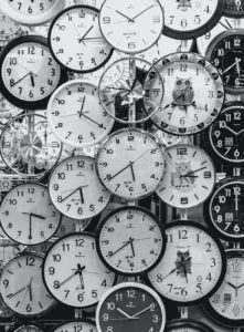 black and white photo of clocks